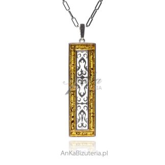 Srebrna zawieszka z żółtym bursztynem i ażurowym pionowym ornamencie
