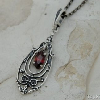 ELEMIS - srebrny wisiorek z granatem